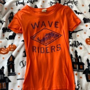 This is a Hollister shirt that has they saying "Wave Rider" on it.